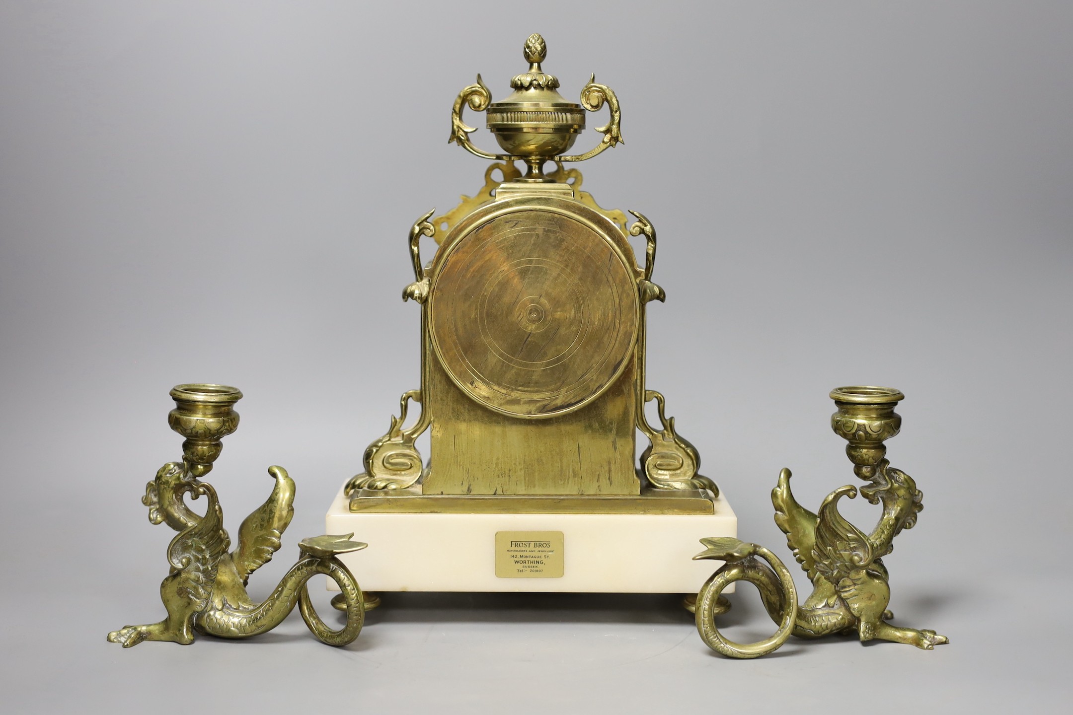 A 19th century French brass and alabaster mantel clock and a pair of dragon candlesticks, clock 28cms high